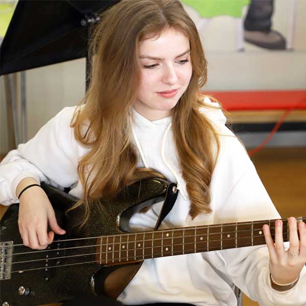 girl playing bass guitar
