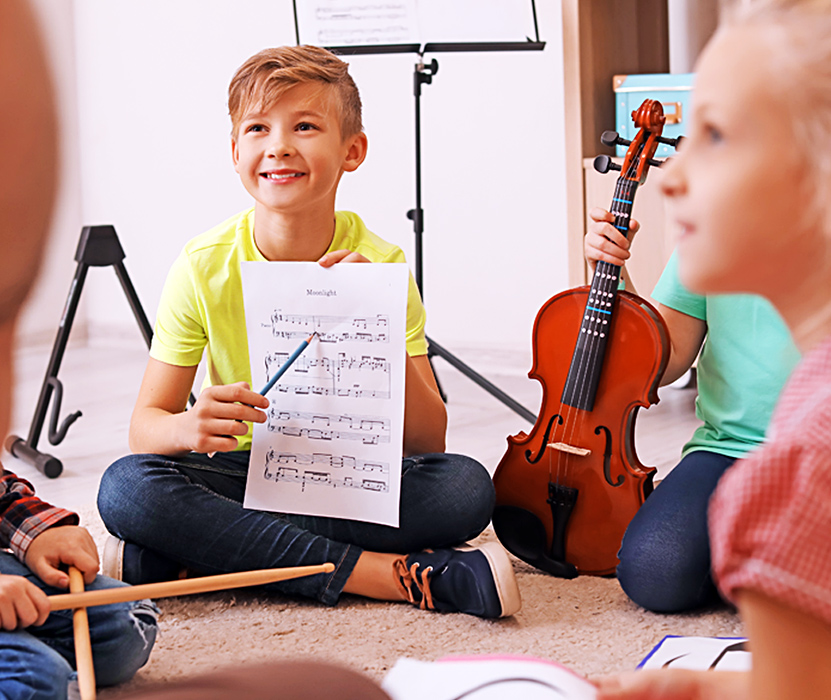 children pointing at music sheet