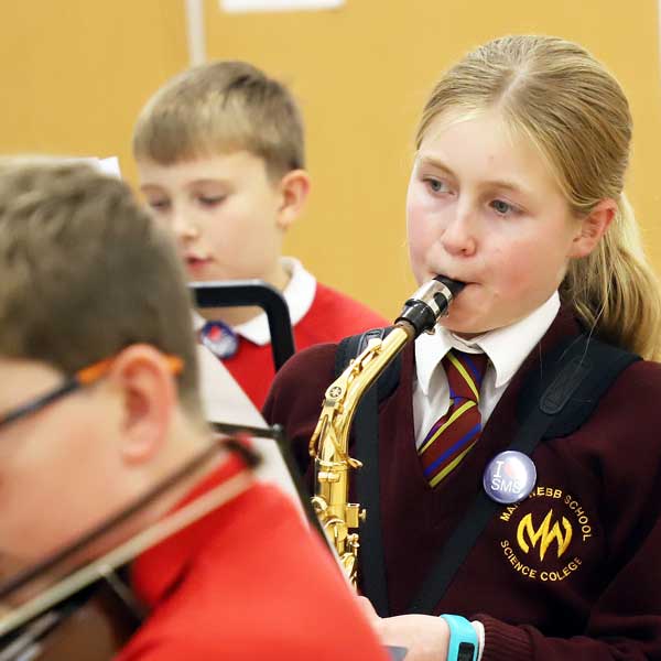 young girl learning saxophone
