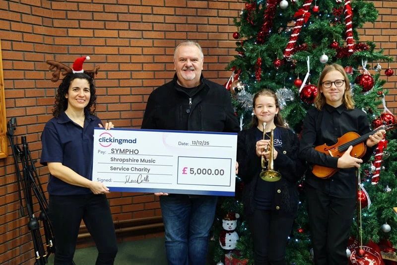 Shaun Carvill from Clickingmad donating a cheque to Sympho charity