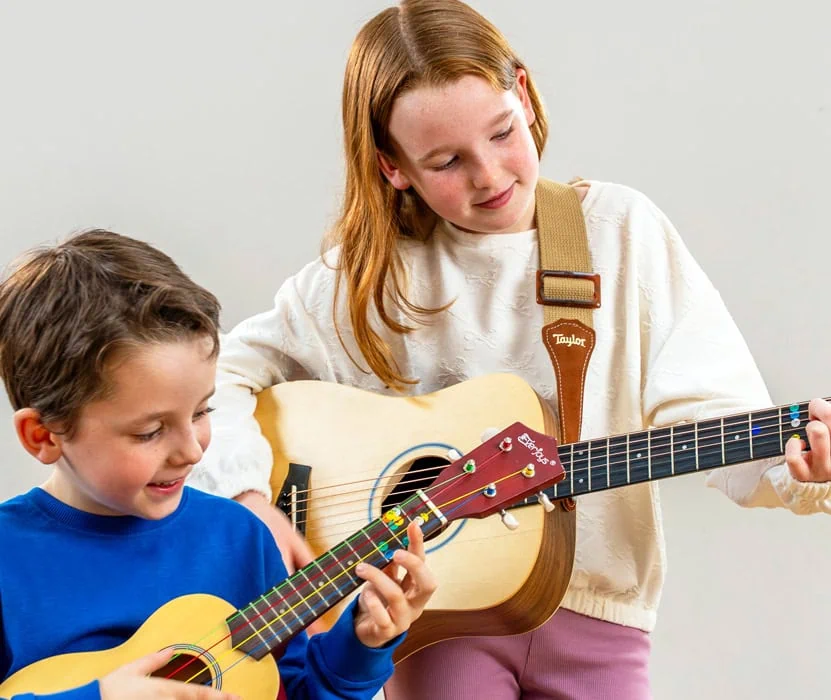 two childing playing guitars together