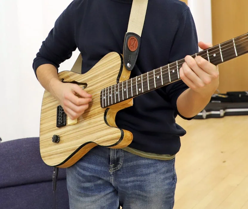 teenager playing the guitar