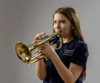 Girl playing trumpet, promoting Shropshire Music Service and music education.